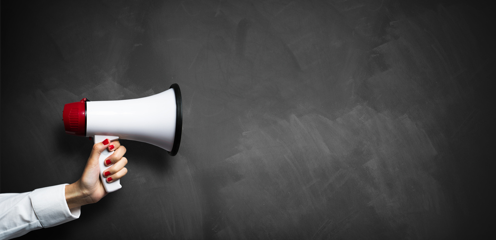 Woman holding up a megaphone.