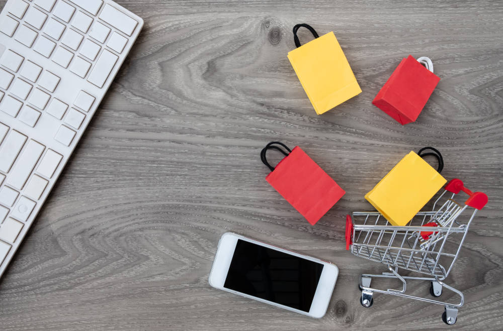 Tiny shopping cart with tiny shopping bags.